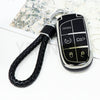 A black durable TPU car key fob cover with a chain attached, featuring panic and lock buttons.