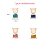 A set of four wooden Montessori busy board parts showing different random colors like teal, blue, pink, and gold.
