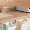 A set of white folding hanging trash cans displayed on a kitchen cabinet shelf.