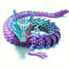 A purple and teal articulated dragon figurine coiled in a ring.