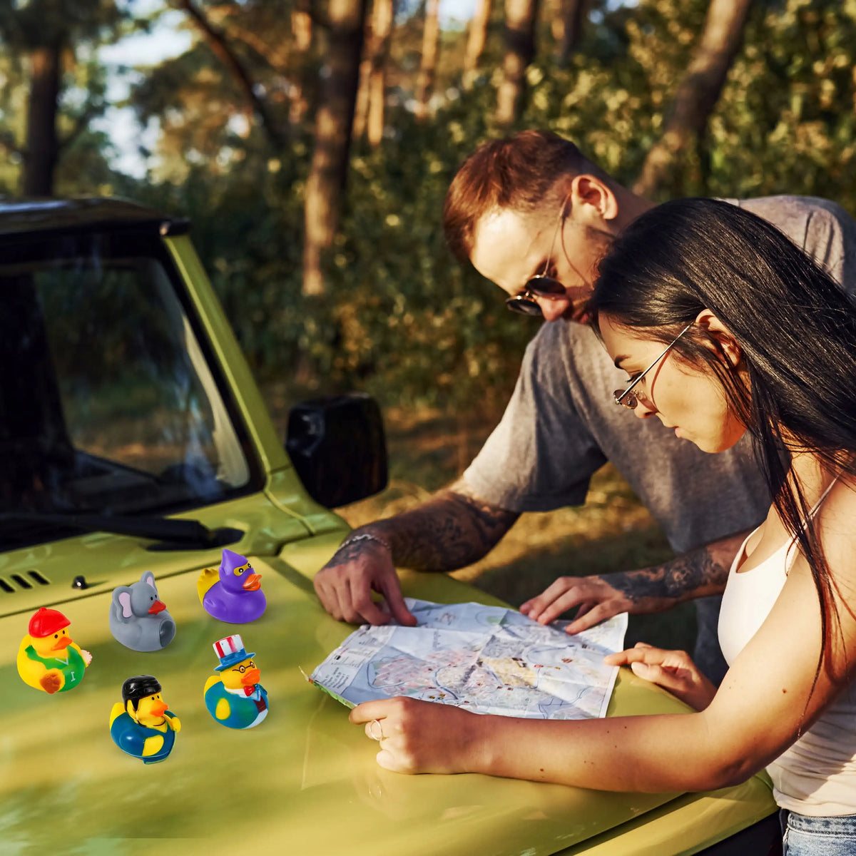 A man and a woman look at a map of rubber ducks on a green vehicle.