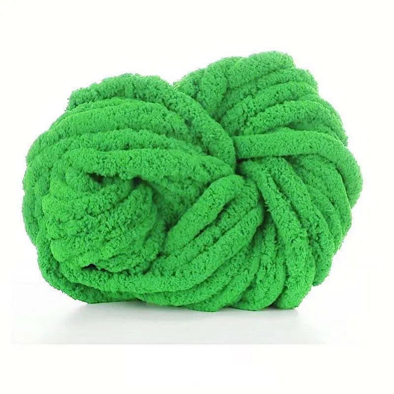 A ball of bright green chunky acrylic yarn for knitting and crochet