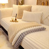 A white plush sofa cushion mat with vertical ribbed texture and layered gray accents on a bed.