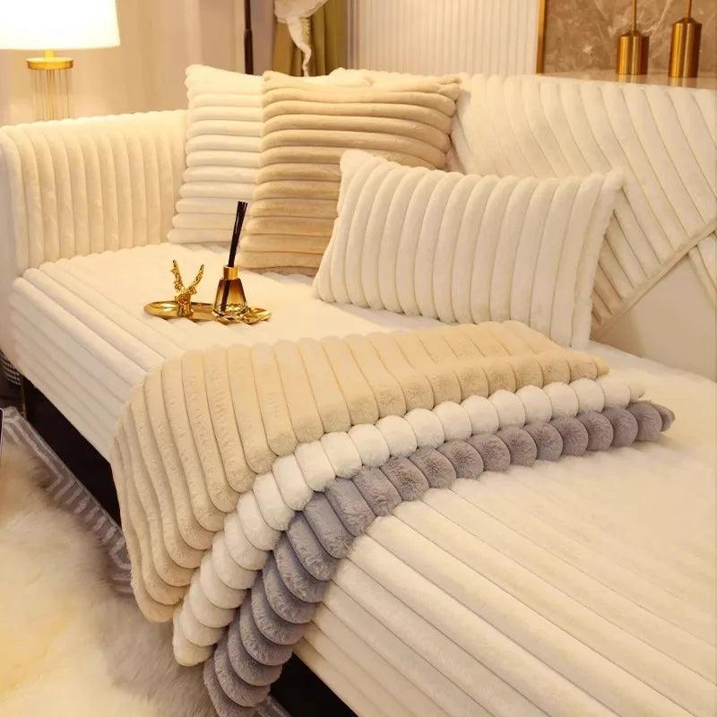 A white plush sofa cushion mat with vertical ribbed texture and layered gray accents on a bed.