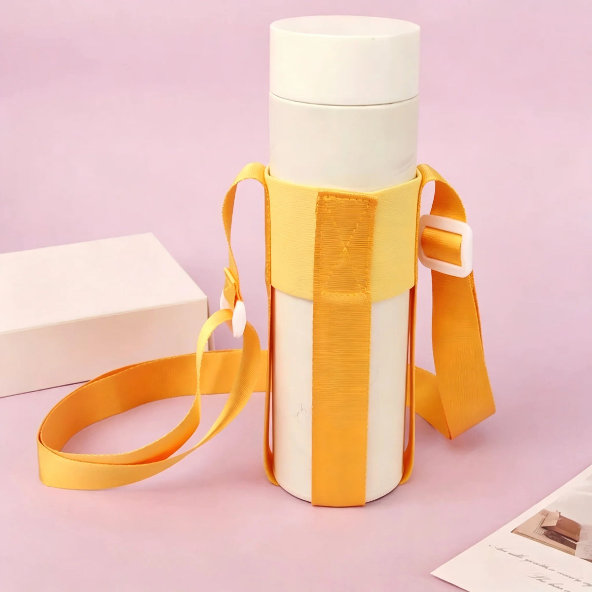 A white water bottle carrier with an orange strap is shown against a light purple background.