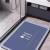 A dark blue non-slip mat is placed on a floor, featuring silverware icons, demonstrating instant water absorption.