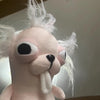 A light pink plush chihuahua dog head with large black eyes and a long tongue.
