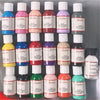 A collection of glass bottles filled with various colored leather pigment dye for shoes, bags, and DIY art projects