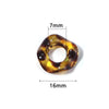 A close-up view of a brown and gold acrylic spacer bead with a wave pattern, measuring 7mm by 16mm.
