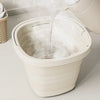 A white collapsible outdoor bucket is being filled with water, creating a mist or steam.