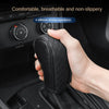 A hand is holding a black PU leather car gear shift cover with diamond stitching.