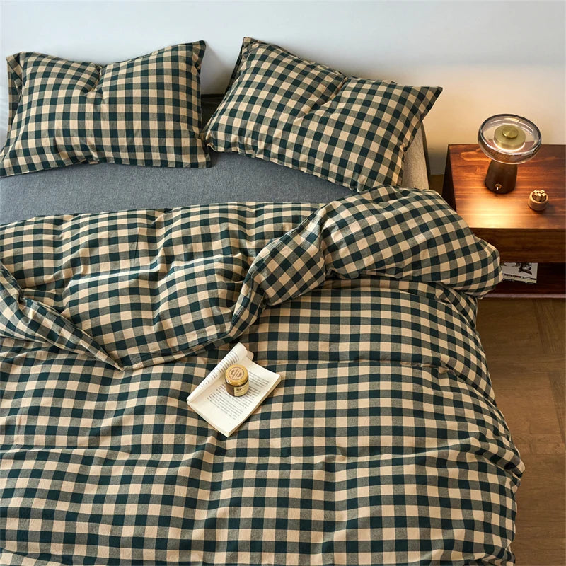 A plaid duvet cover in olive green and beige tones with a grid pattern is displayed on a bed.