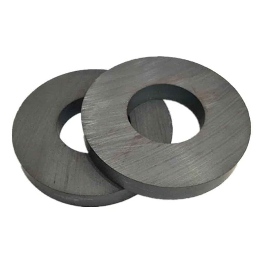 Two industrial-grade ceramic ring magnets with a dark gray finish.