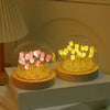 Handcrafted tulip LED night light with pink and yellow flowers inside a glass dome on a wooden base