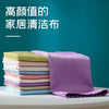 A stack of purple and green lint-free microfiber household cleaning cloths on a white table.