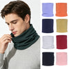 A man wearing a dark green neck warmer scarf, with various colored options displayed beside it.
