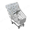 A silver shopping cart with a light patterned fabric cover placed on a rolling frame.