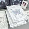 A white loose-leaf photo album featuring a butterfly and rose design for K-Pop cards and memories