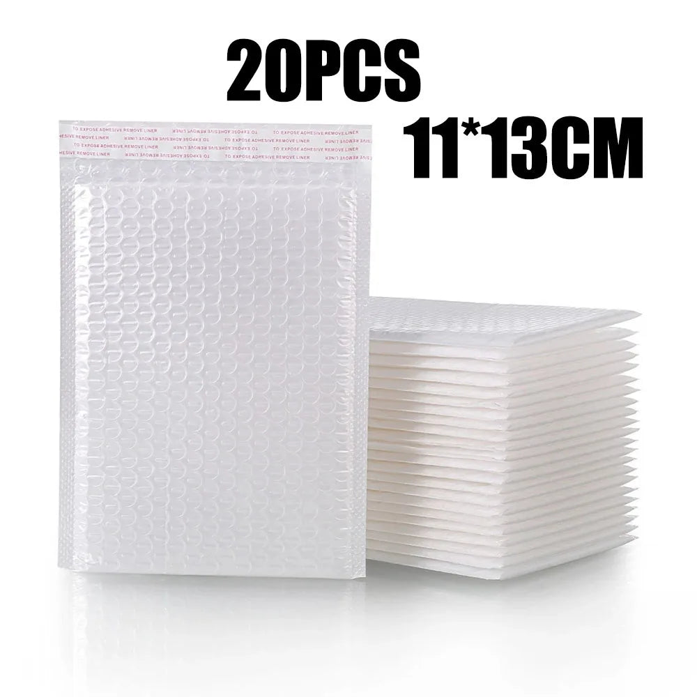 A stack of 20 white padded bubble mailers, measuring 11x13cm each.