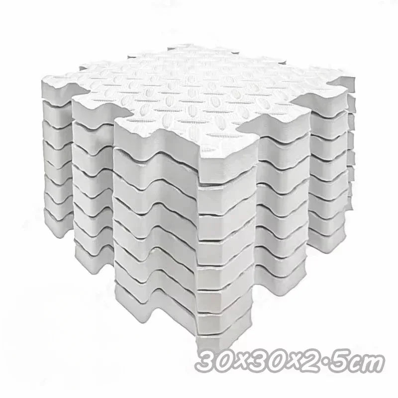 A stack of white interlocking foam play mats for babies and toddlers.