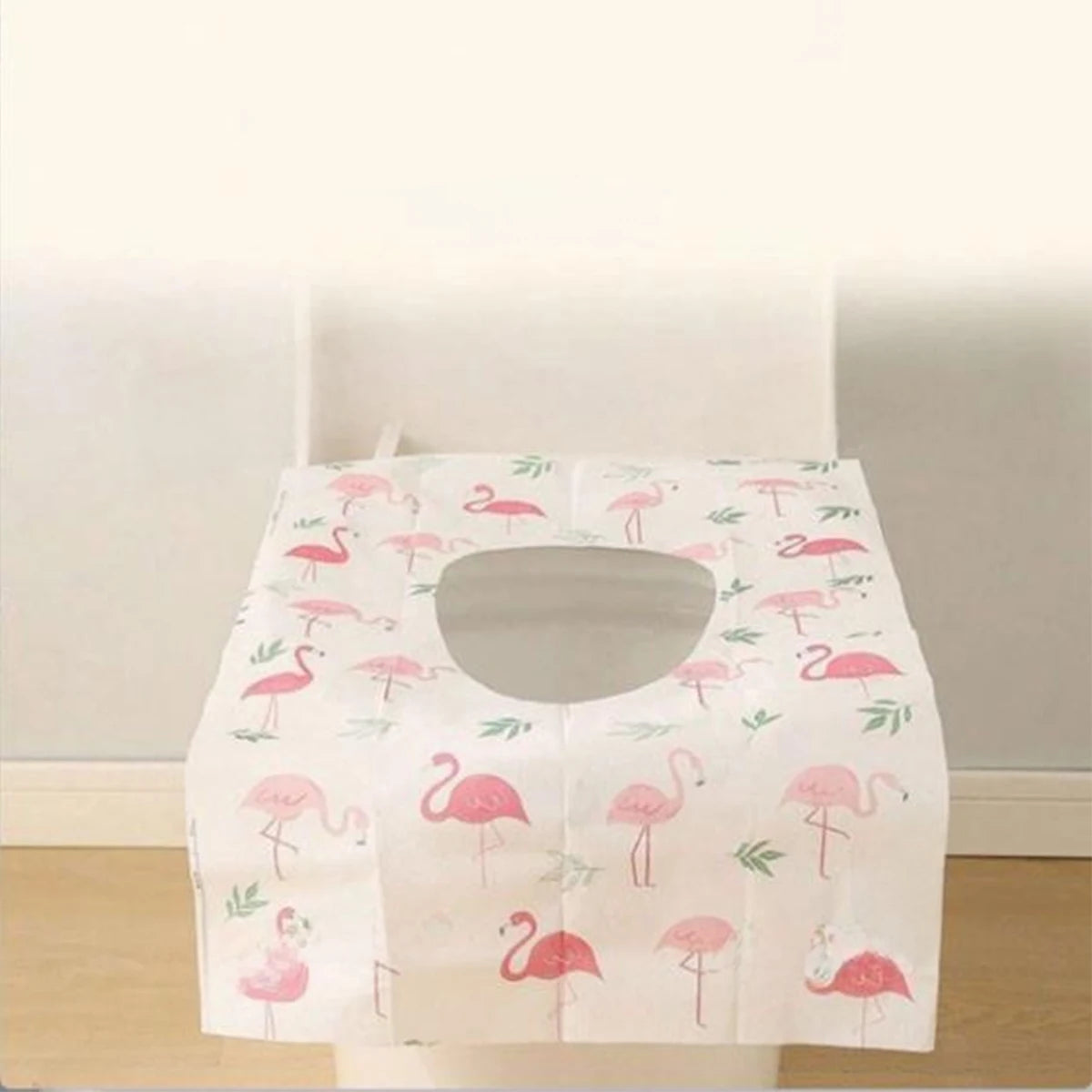 A pack of pink flamingo disposable toilet seat covers for travel and public restrooms.