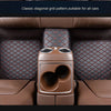 Interior view of a car seat showing classic diagonal grid pattern leather floor mats and audio speakers