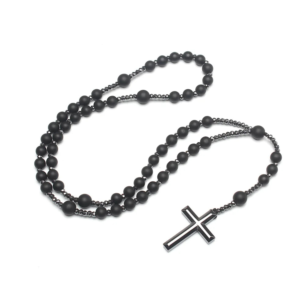 A black tiger-eye stone cross pendant necklace with multiple strands of black beads.