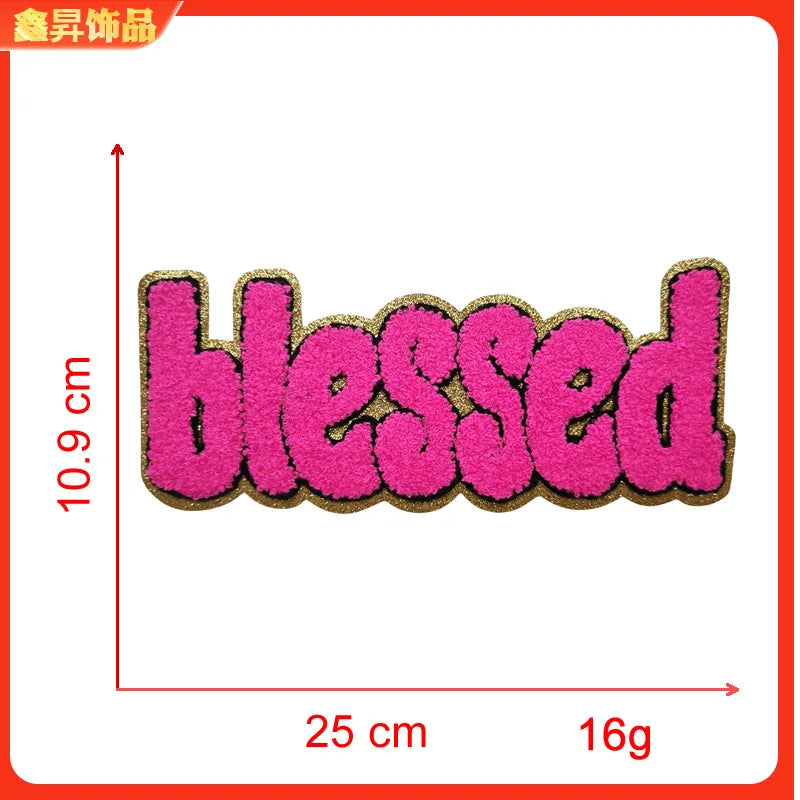Pink embroidered patch with the word blessed on a gold backing