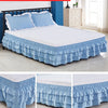 Blue monochrome three-layer bed skirt with ruffled edges covering a white mattress.