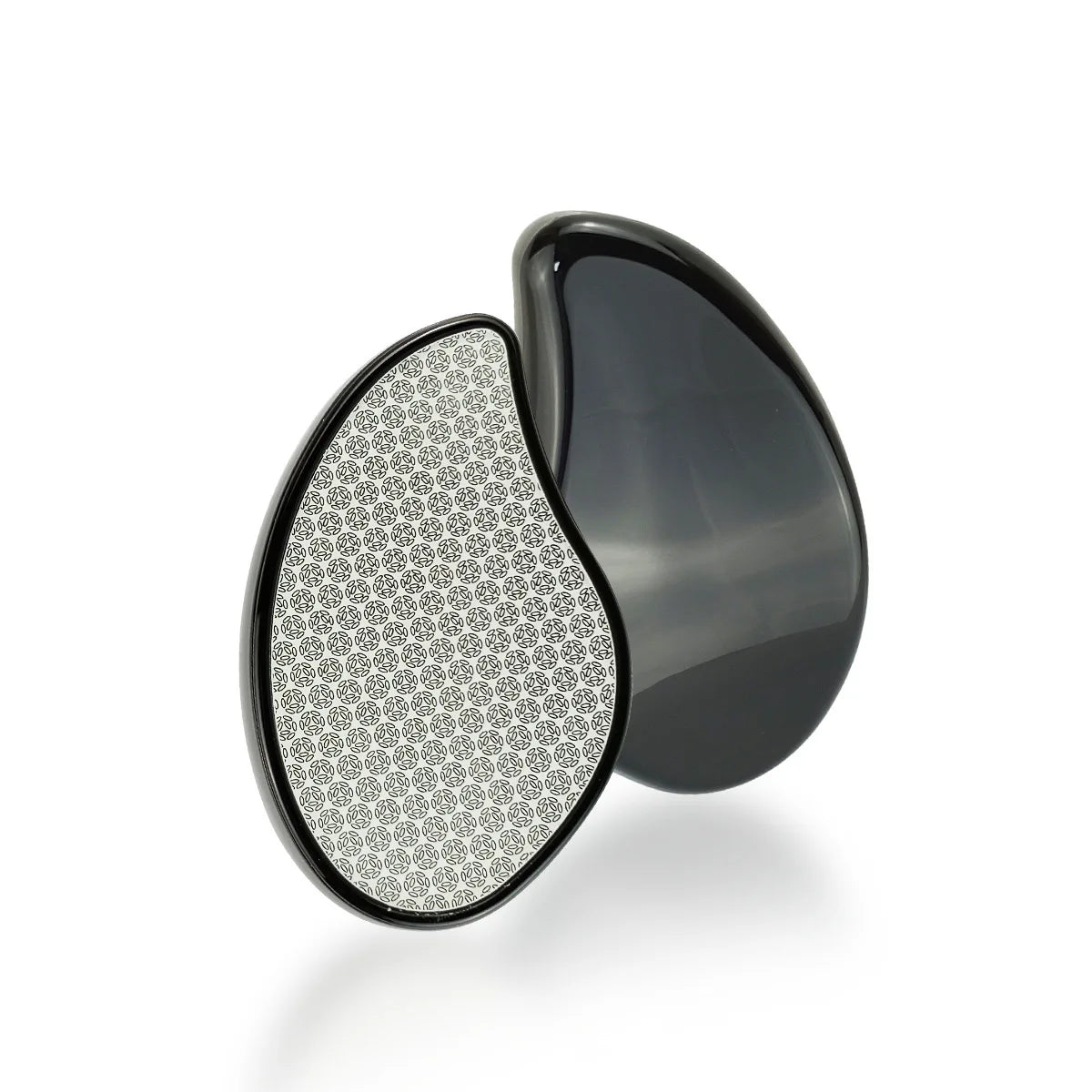 A black glass hair remover with a pear-shaped design and a patterned surface.