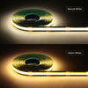 A roll of natural white and warm white touch-dimming COB LED strip lights shown illuminating a surface.