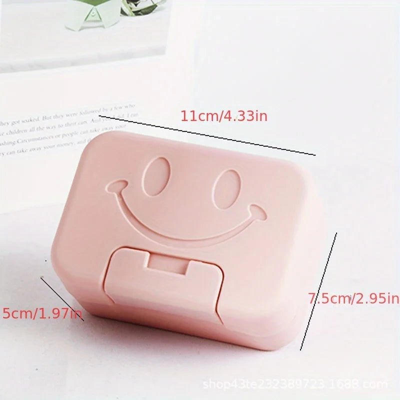 A pink smiley face lidded soap dish for bathroom and travel, shown from the side.