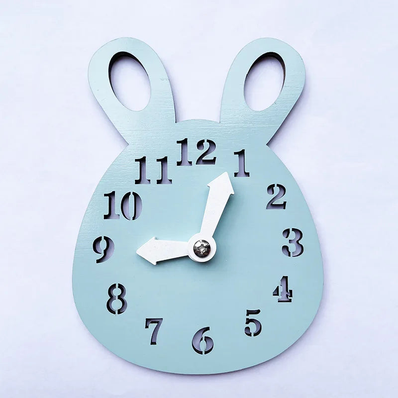 A light blue wooden Montessori clock with a decorative bunny shape and numbers on the face