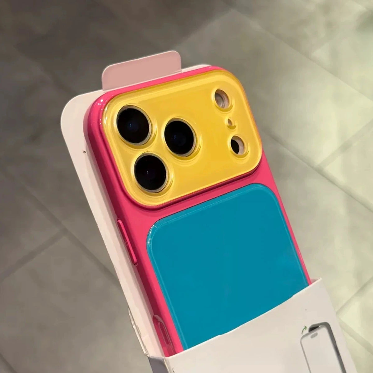 A color blocking shockproof phone case featuring a large camera window and a vibrant blue back panel.