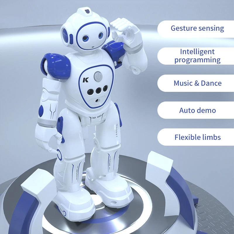 A white interactive dancing robot toy with blue accents is shown standing on a circular platform.