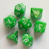 A collection of seven green polyhedral dice showing various numbers and patterns on a white surface.