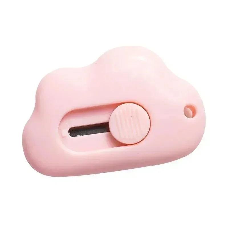 A pink compact rabbit mini cutter with a retractable blade and a round button.