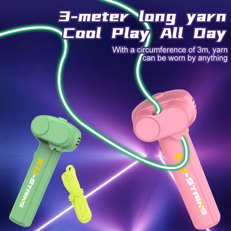A pink glow-in-the-dark yarn string launcher toy is shown with a green yarn, demonstrating its use.