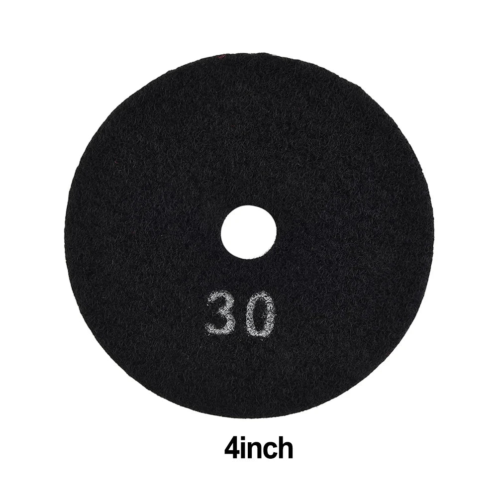 A round, black diamond polishing pad with a center hole and the text 30 and 4inch printed on it.