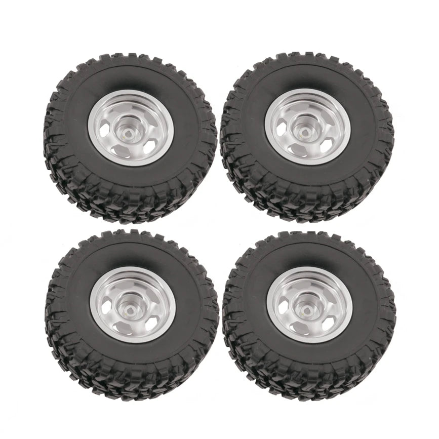 A pack of four black RC car upgrade wheels with shiny metal rims and soft tires.