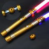 A golden lightsaber with a pink and blue blade is shown next to its hilt and emitter piece.