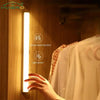 A vertical LED light strip mounted on a wooden panel, illuminated by a hand near the sensor.