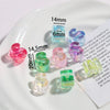A collection of colorful acrylic alphabet beads displayed on a white plate with measurements.