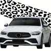 White car with a black leopard print sunshade decal strip on the windshield.