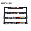 A pair of black racing style license plate frames with JDM aesthetic design.