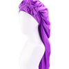 Purple satin sleep bonnet with an adjustable tie draped over a white mannequin head.