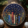 A circular embroidery hoop featuring floral elements and stacked fabric strips in various colors like blue, yellow, and red.
