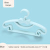 A white bow hanger for baby clothes, showing its flexible and durable design.