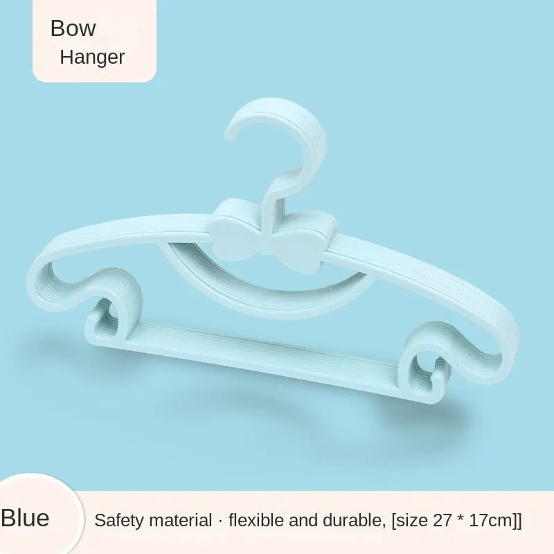 A white bow hanger for baby clothes, showing its flexible and durable design.