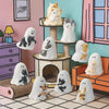 A collection of white ghost-like figurines depicting cats and other animals displayed in a colorful room setting.
